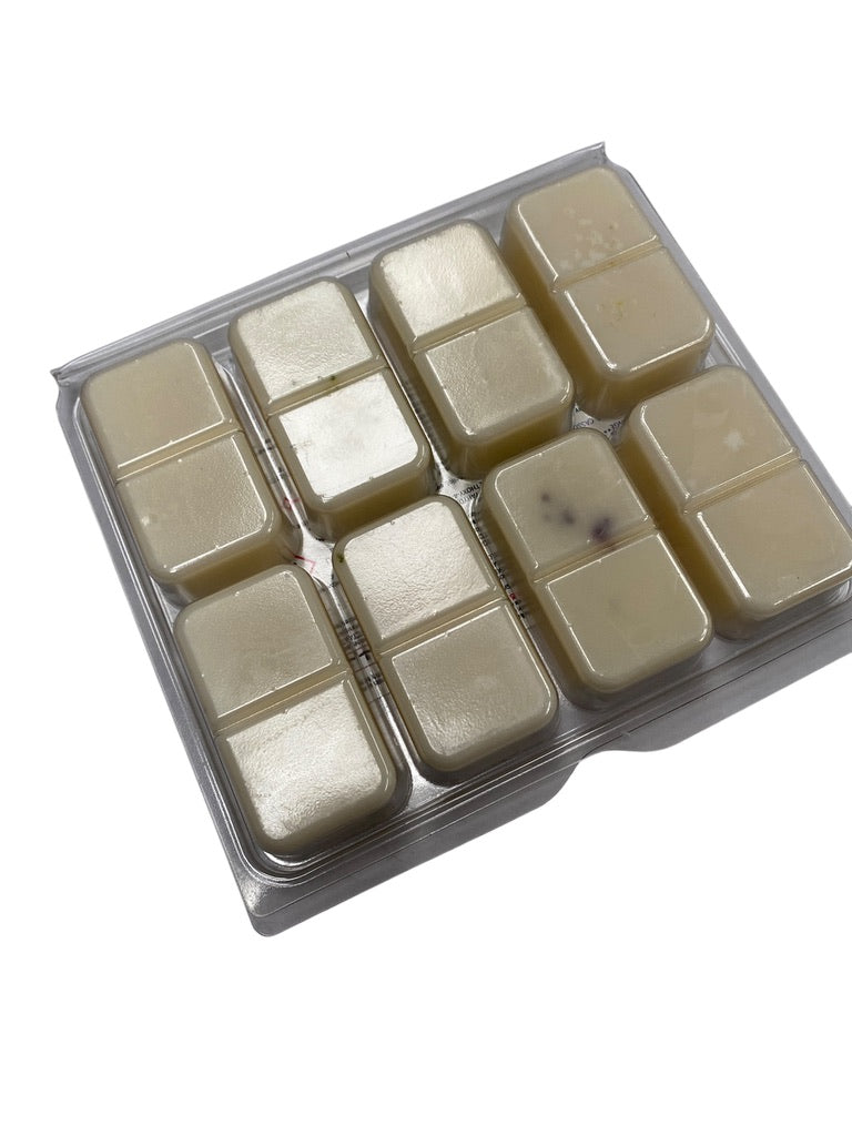 Close-up of botanical scented wax melts including carrot blossom and fennel, lime basil and mandarin, and blackberry and bay.