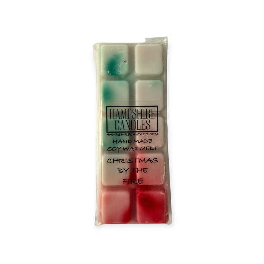 Christmas By The Fire soy wax melts warming in a burner in a cosy festive home with Christmas decorations and fireside atmosphere.