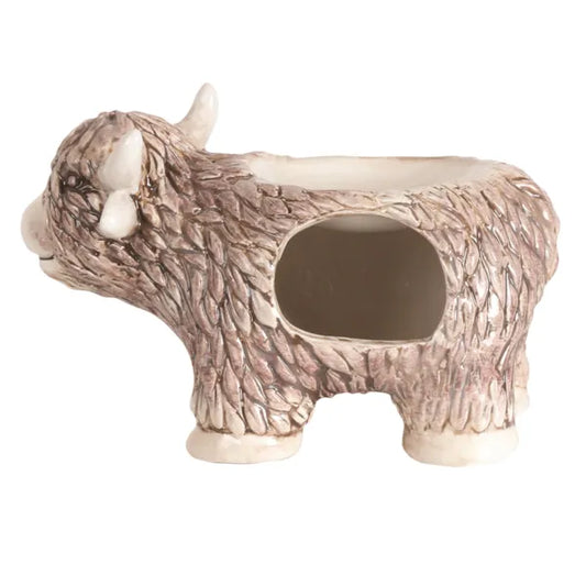 Side View: A side profile of the Highland Cow wax melt burner, showing its intricate features and wax melt dish.