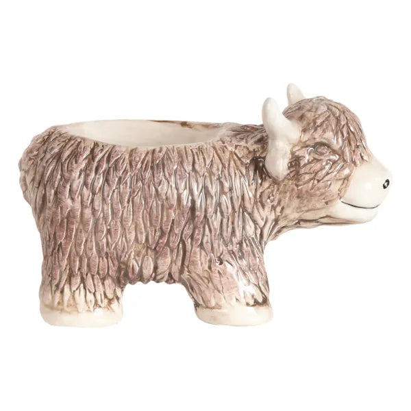 In Use: The Highland Cow wax melt burner with a lit tea light, gently warming wax melts to release fragrance.