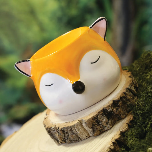 Side View: A side profile of the fox wax melt burner, showcasing its intricate features and wax melt dish.