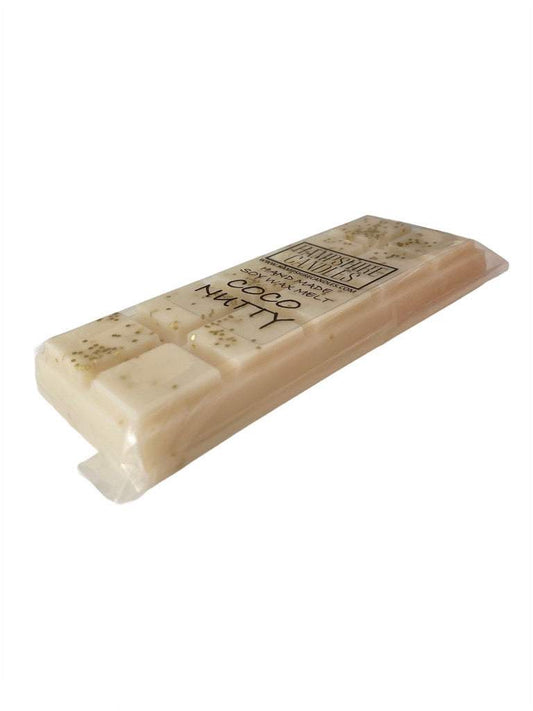 Coconutty Wax Melts in Burner – A wax melt melting in a burner, releasing a rich and exotic coconut scent.