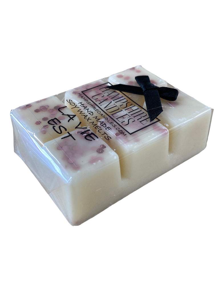 La Vie Est Wax Melts with Flowers & Candles – A beautifully styled scene with wax melts, fresh flowers, and candles, creating a luxurious setting.