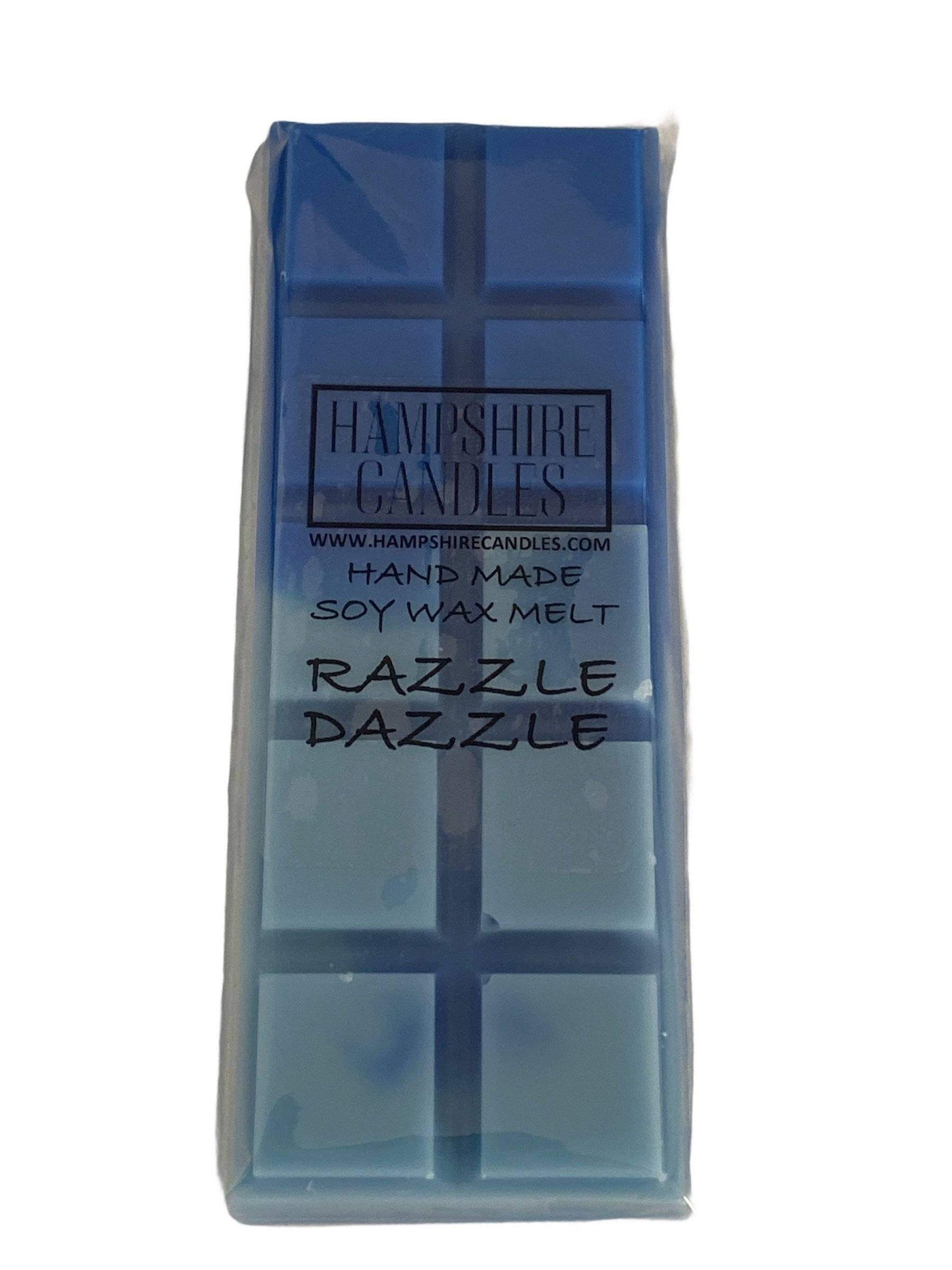 Razzle Dazzle wax melt gently melting in a ceramic burner, releasing fruity and floral fragrance of pineapple, jasmine, and orange blossom.
