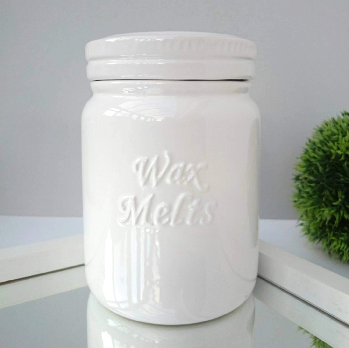 White ceramic wax melt storage jar with embossed lettering and soft-close lid – elegant scent storage container for the home