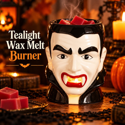 Dracula tealight wax melt burner glowing through its fanged mouth as the tealight warms red wax melts