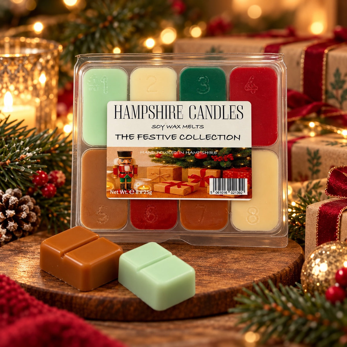 Festive Collection soy wax melts on a wooden board with pine cones, fairy lights and wrapped gifts, caramel and green melts