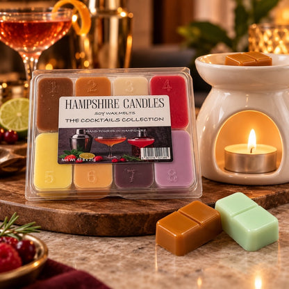 Cocktails Collection soy wax melts by a lit tealight burner and a cocktail glass, with caramel and mint melts on wood