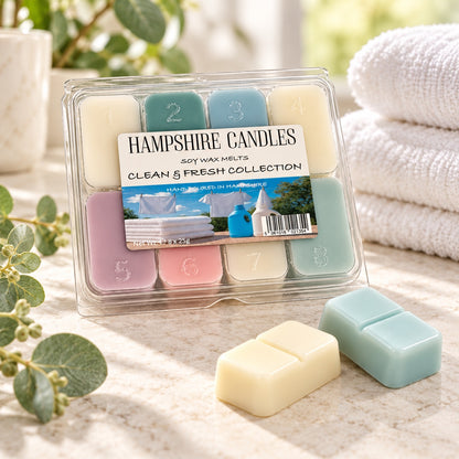 Clean & Fresh Collection selection box on a bathroom counter with fluffy white towels, eucalyptus and two loose melts