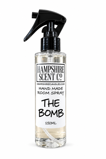 A 150ml clear room spray bottle with a black trigger spray top and a white label reading 'Hampshire Scent Co. The Bomb'.