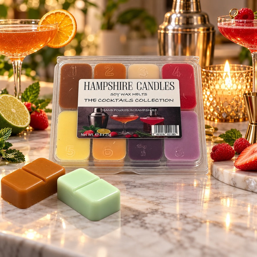 Cocktails Collection wax melt selection box in a glowing bar scene with cocktail glasses, orange slices and two loose melts