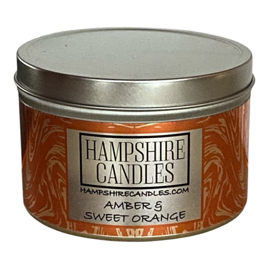 A soy wax candle tin with Amber & Sweet Orange fragrance, offering a warm and inviting aroma ideal for relaxing evenings.