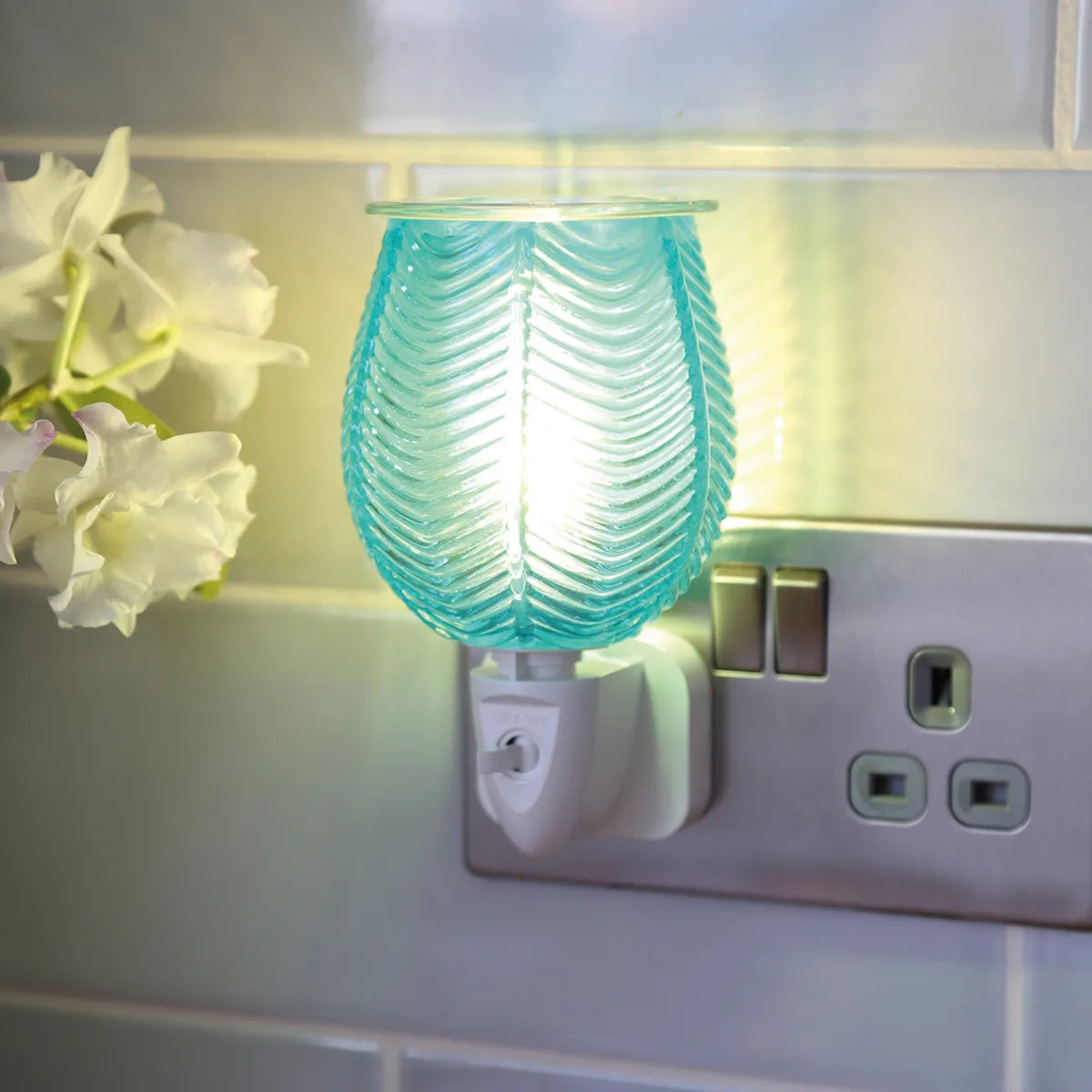 Aqua lustre plug in wax warmer illuminated with warm ambient glow