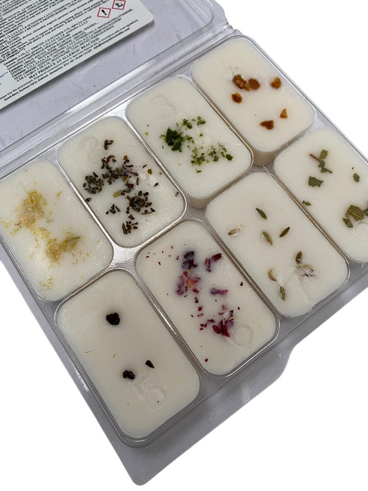 Close-up of botanical scented wax melts including Pear & Freesia, Wild Fig & Cassis, and Velvet Rose & Oud.