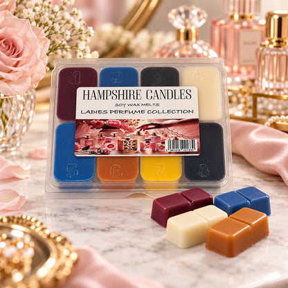 Perfume Collection soy wax melts on a dressing table with pink roses and glass perfume bottles, four loose melts by the pack