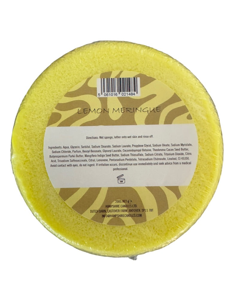 Close-up of Lemon Meringue scented soap sponge on white background, showing rich texture and eco-friendly packaging.