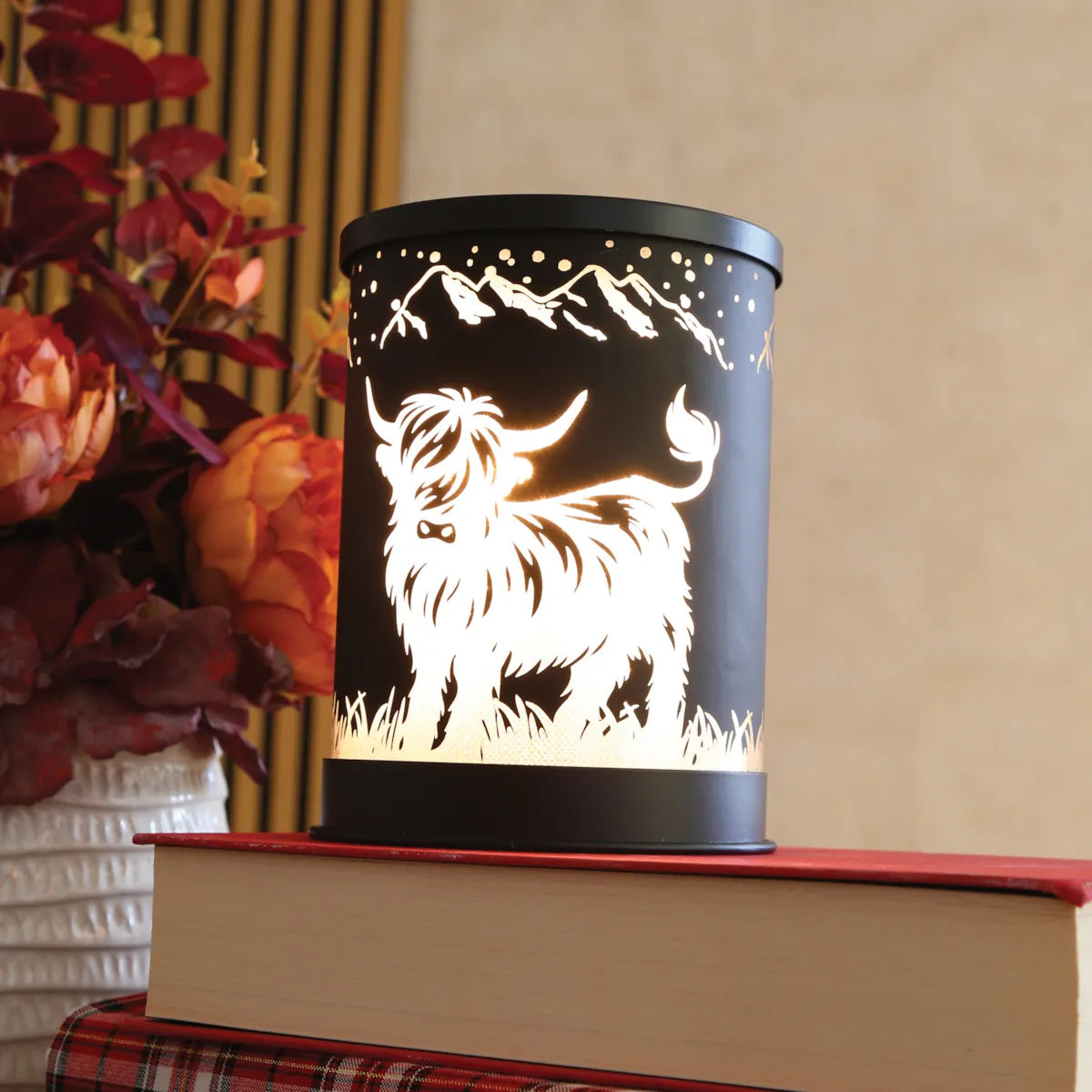 Electric Highland Cow wax warmer with illuminated mountain silhouette design and glass dish