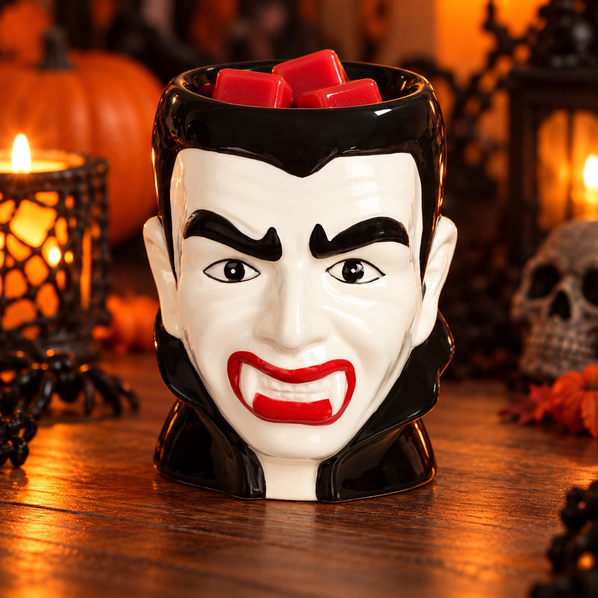 Ceramic Dracula tealight wax melt burner displayed with candlelit lanterns and a skull for spooky season