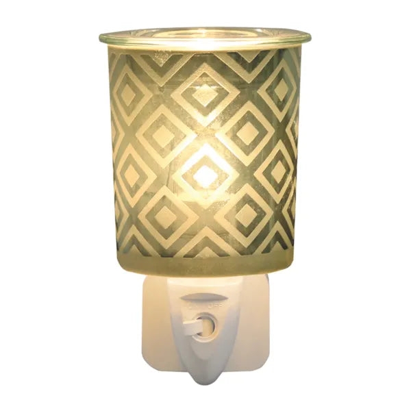 Green diamond plug-in wax melter fitted into a UK mains socket showing glass dish and on/off switch, 13cm electric wax melt warmer
