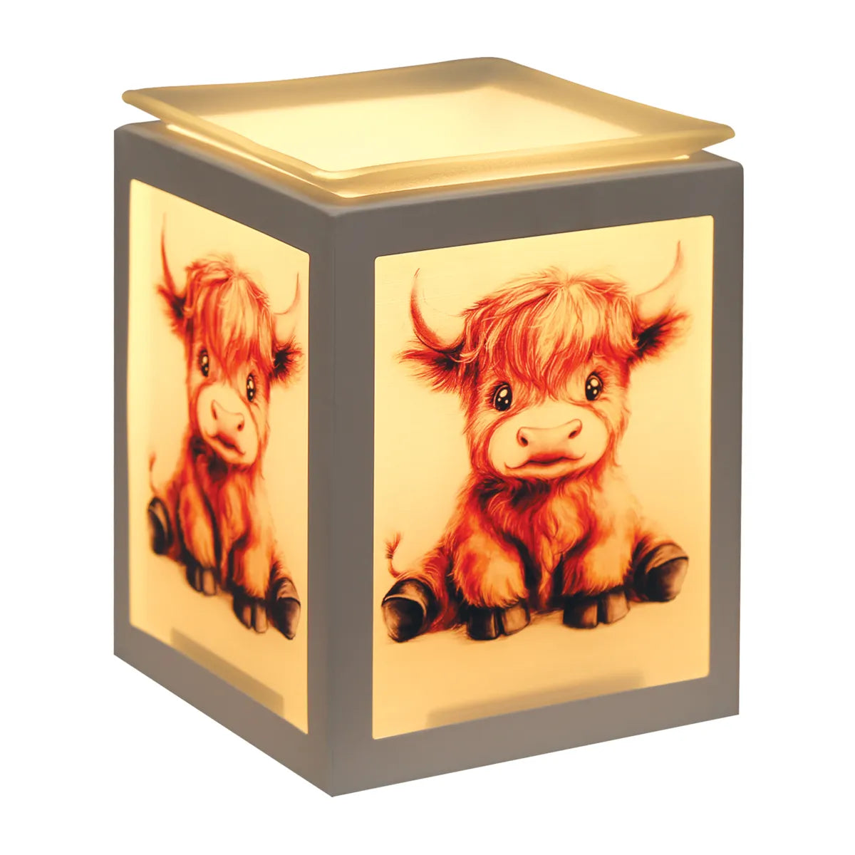 Highland Calf electric wax melt burner illuminated in a cosy home while gently warming scented wax melts in the glass dish.
