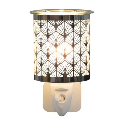 Illuminated chrome fan wax warmer creating a warm ambient glow
