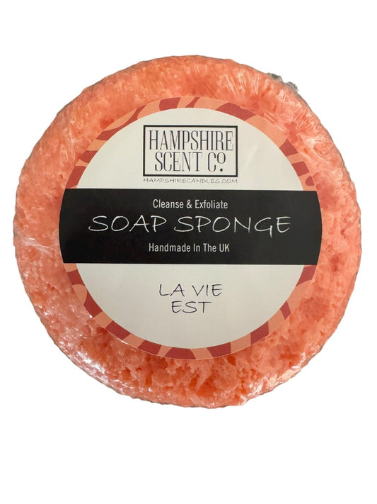 "La Vie Est soap sponge inspired by luxury perfume displayed in bathroom"