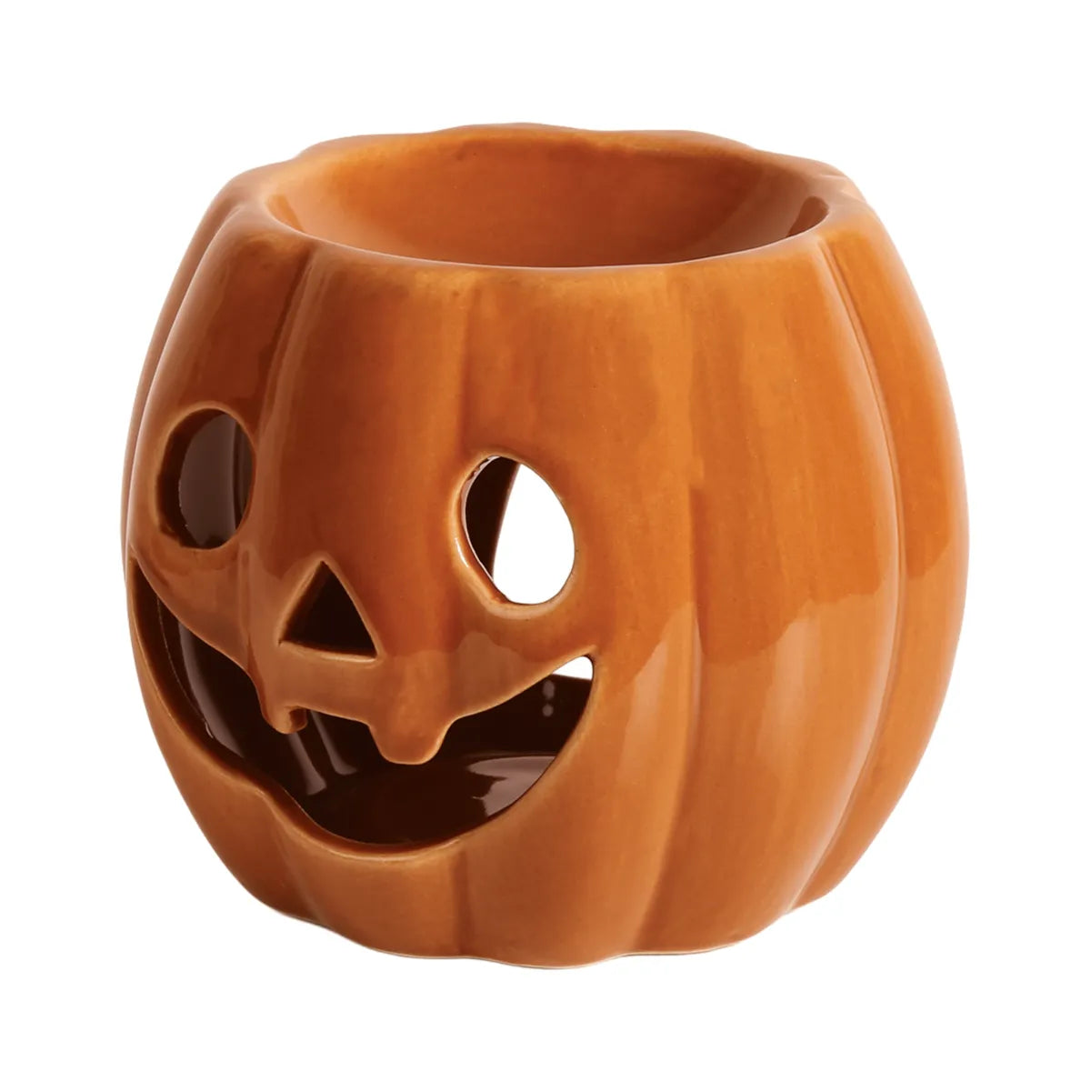 Orange Pumpkin tealight wax melt burner glowing in a cosy autumn home while gently warming scented soy wax melts.