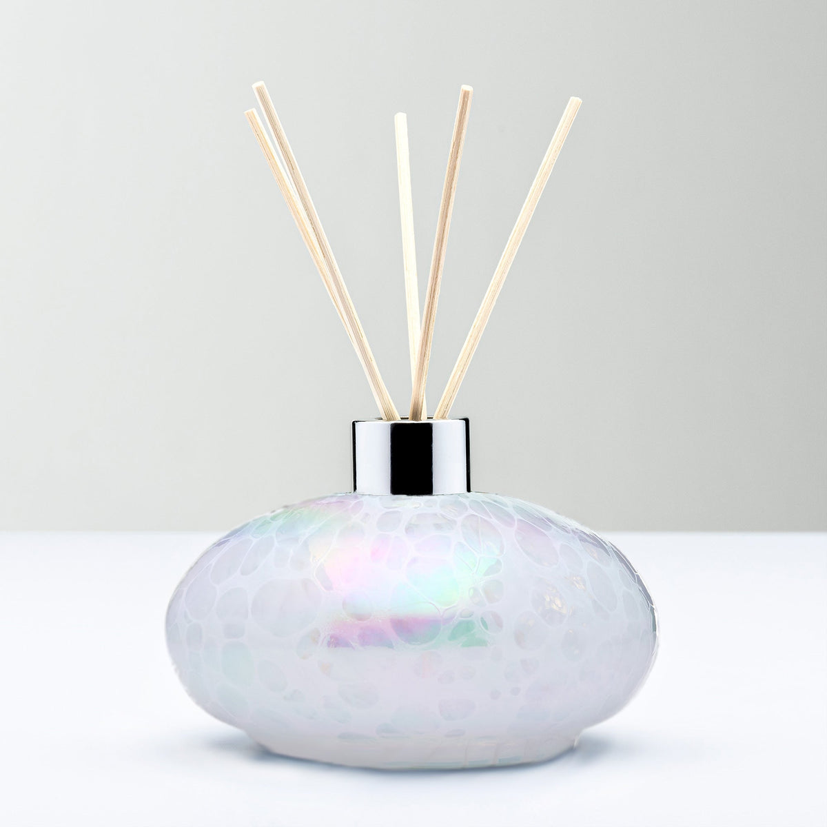 White decorative reed diffuser bottle in mouth-blown glass
