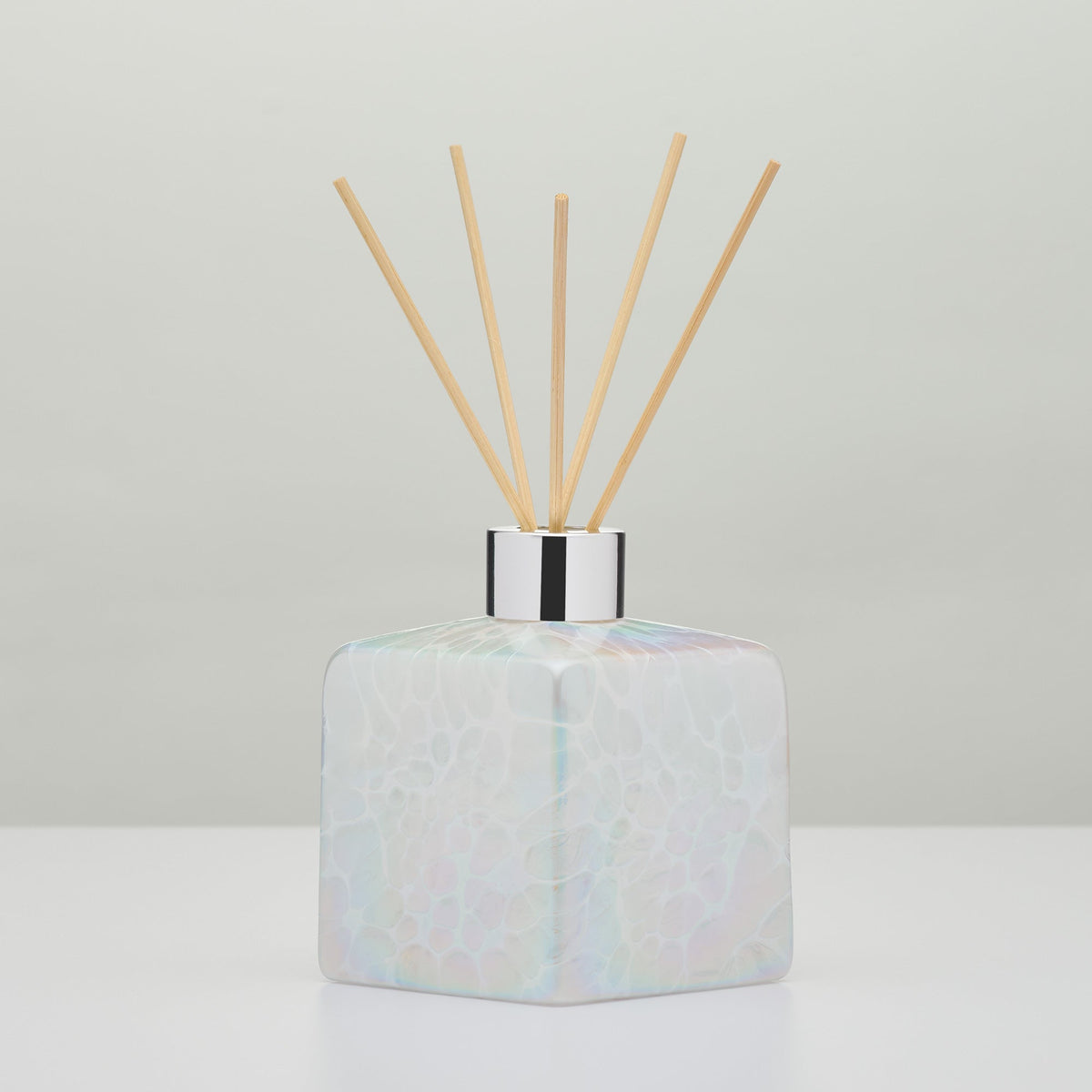 White decorative reed diffuser bottle in mouth-blown glass