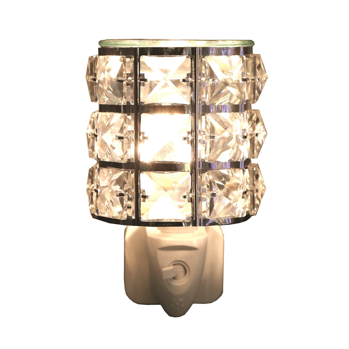 Metal and crystal plug-in wax melt burner, square crystals around a lit bulb, glass dish on top and on/off switch on the white plug