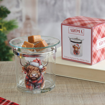 Festive Highland cow glass wax melt burner holding wax melts, beside its red tartan gift box