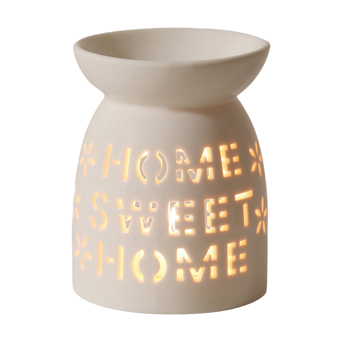 Home Sweet Home ceramic wax warmer with a lit tealight glowing through the lettering