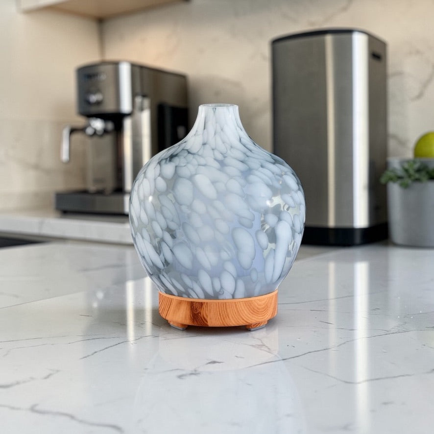 silver ultrasonic aroma diffuser releasing mist with essential oils