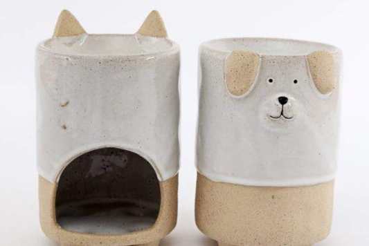 Side view of stoneware wax melt burner featuring adorable dog and cat details.