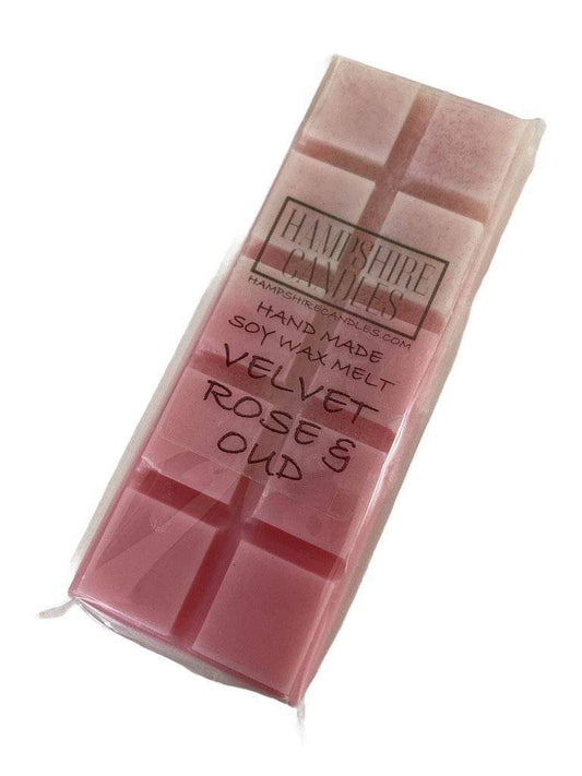 Velvet Rose and Oud Wax Melts displayed in clamshell packaging with elegant label, surrounded by dried rose petals for a luxury aesthetic.